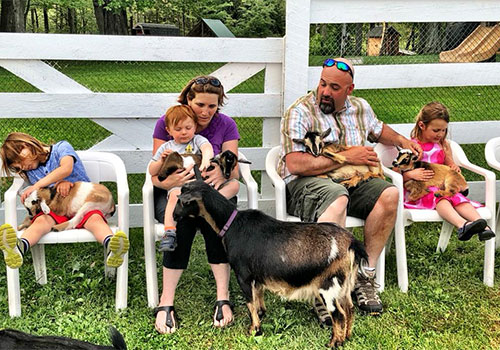 Snuggle a baby goat at Smiling Hill Farm in Westbrook, Maine Snuggle a baby goat at Smiling Hill Farm in Westbrook, Maine